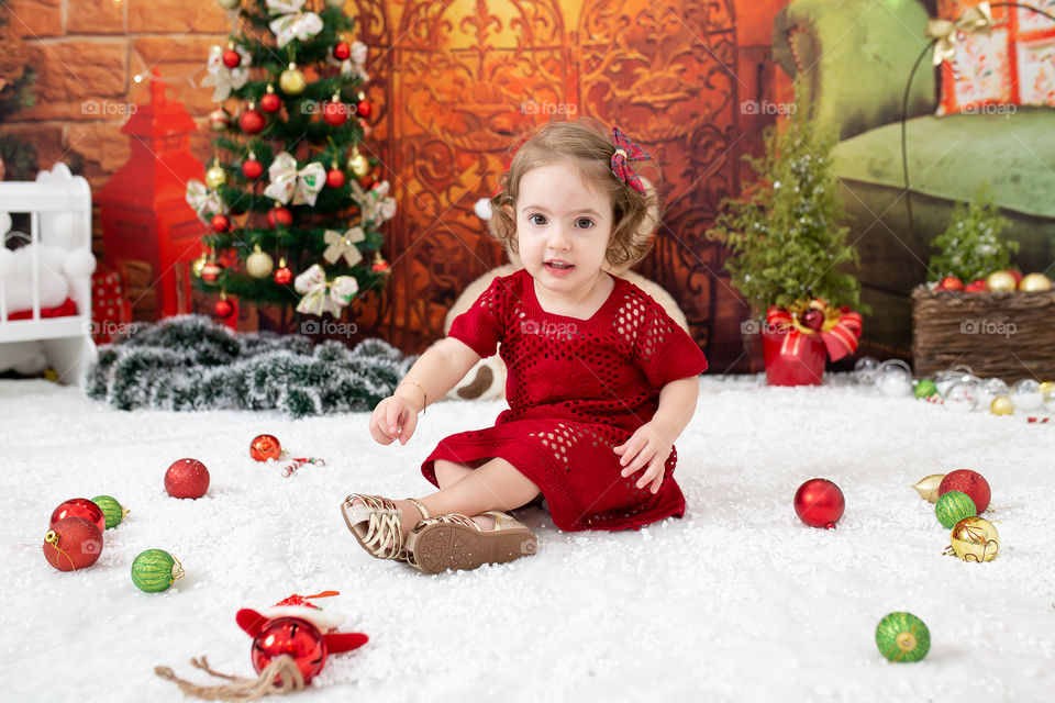 Baby girl playing with christmas balls