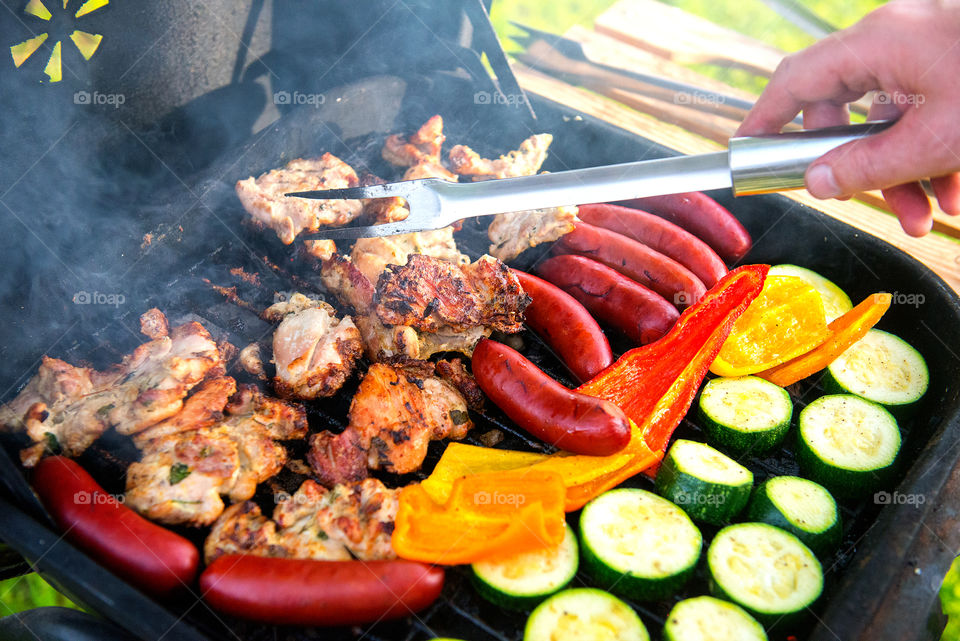 Grilled vegetables and meat on the grill, outside