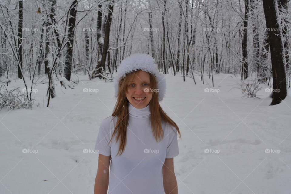 Happy girl in winter forest