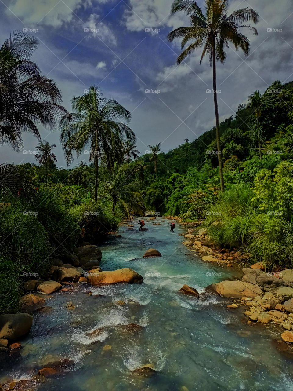 Panoramic landscape of bright blue river of dua rasa river and tropical rain forest
