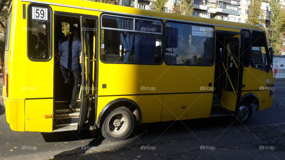 This yellow bus takes hud reds of people to work every day.