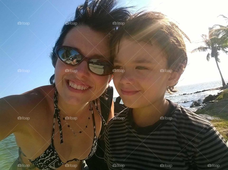selfie of mother and son in an afternoon of sun on the beach