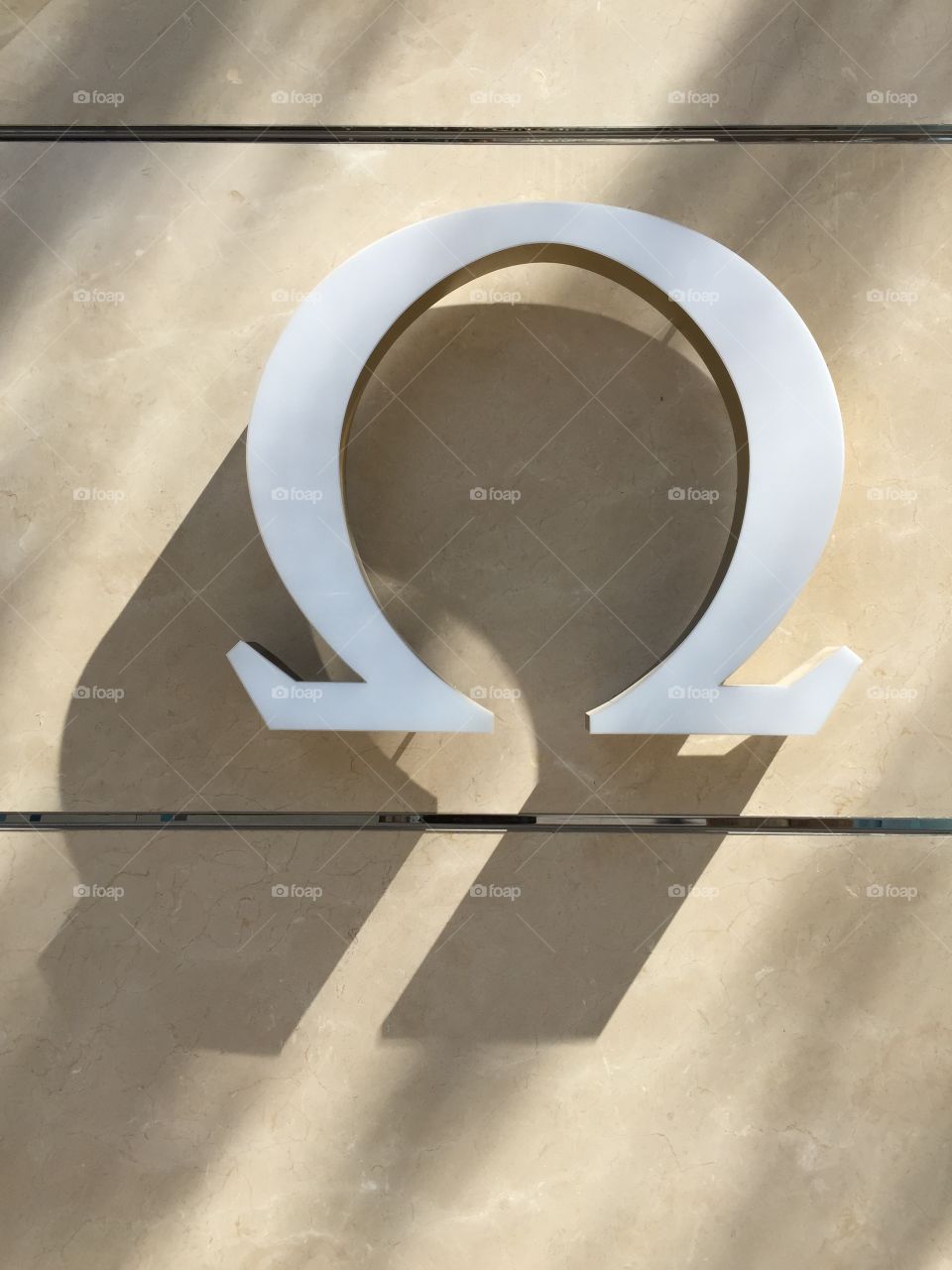 Omega. Omega watch logo on wall outdoors, Design District, Miami, Florida 