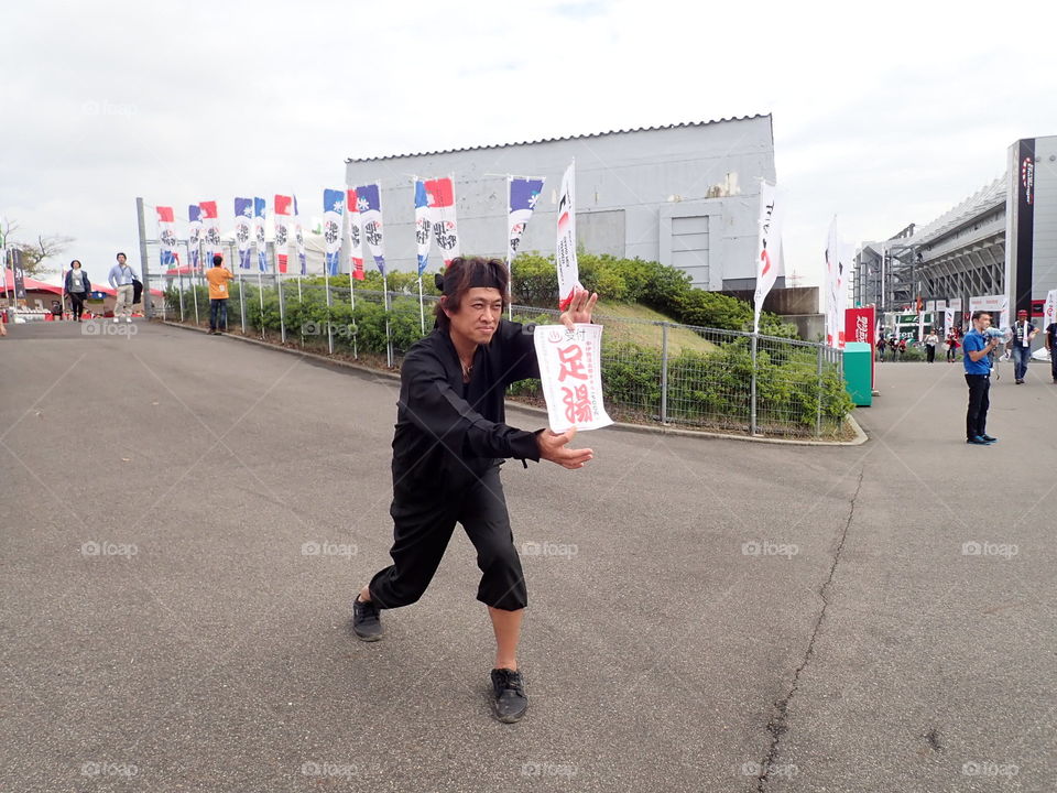 Japanese man posing with sign