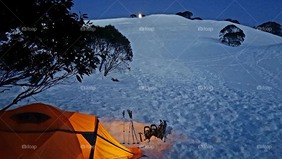 Snow camping with moon setting