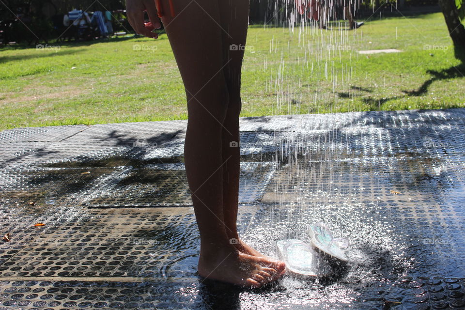 Summertime (child playing with water in the garden)