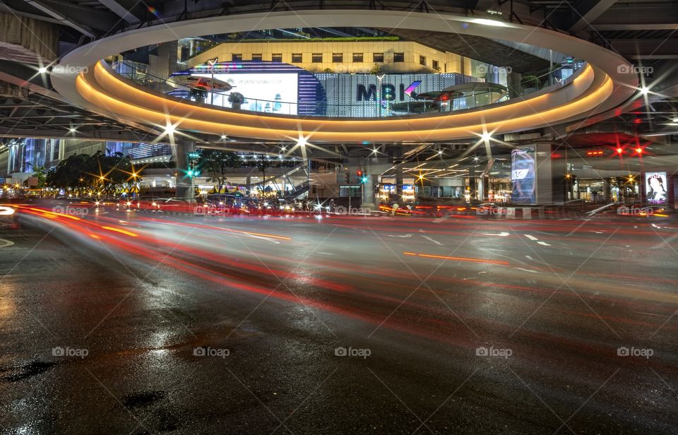 Beautiful Vehicle headlamp light at U turn road in front of the most famous shopping center MBK , Bangkok Thailand