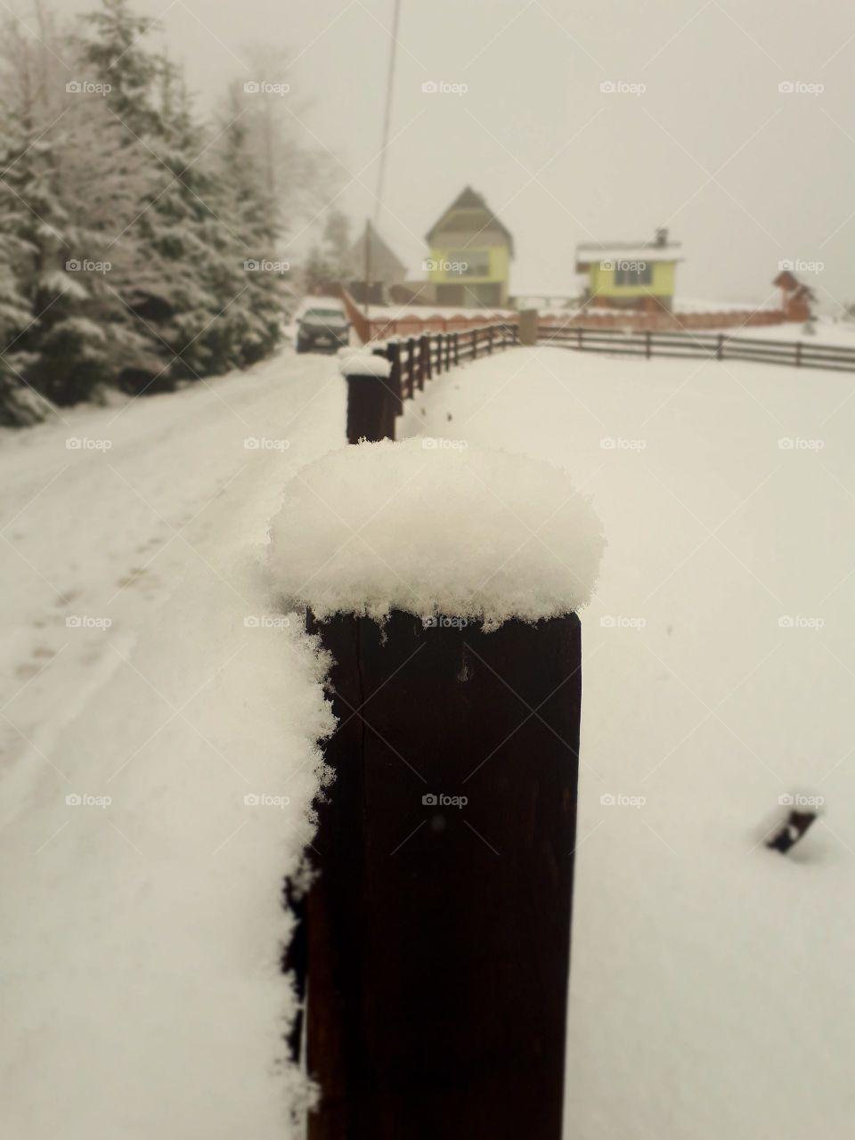 snow on the fence pillar