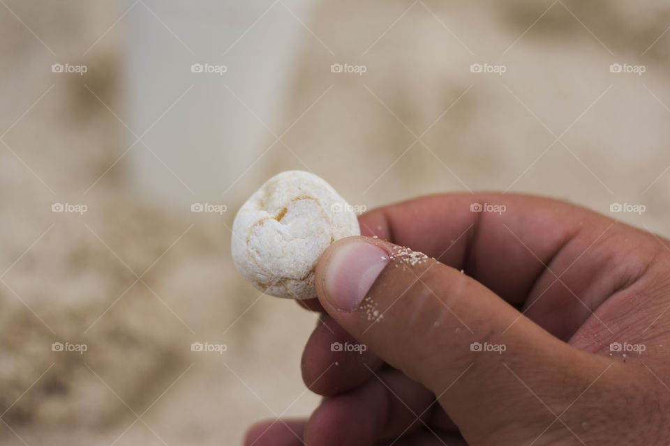 heart of stone. heart in stone held by male hand