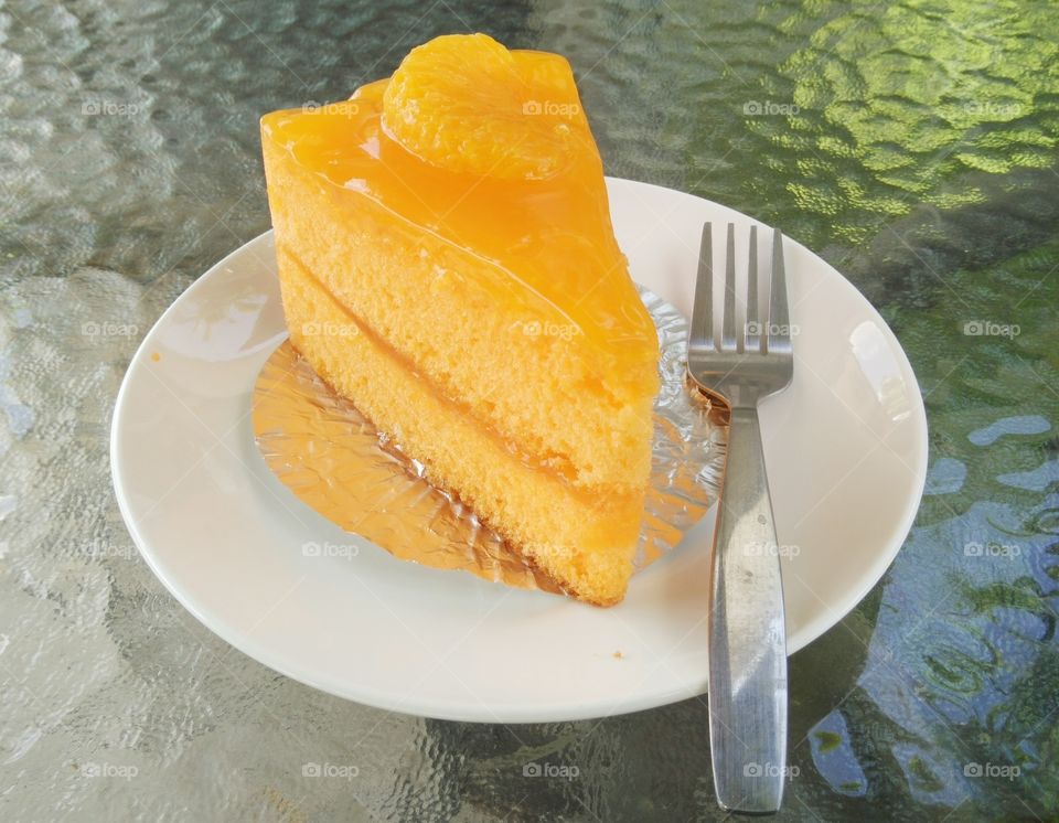 Close-up of orange cake with fork
