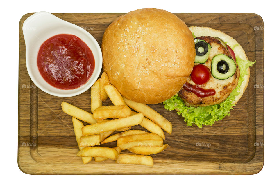 Burger, hamburger or cheeseburger served with french fries and ketchup on wooden board. Hamburger made in the form of a face