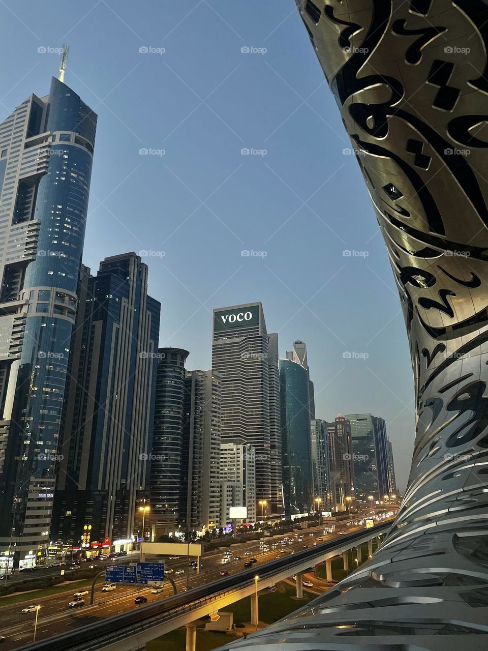 Amazing view from the Museum of future, Dubai. Lights start appearing, cars are turning to cafes and restaurants to enjoy a meal after sunset.