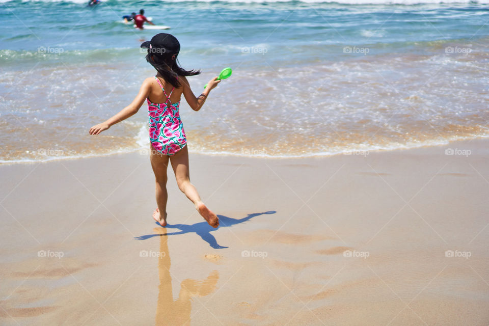 An excited kid playing at the shore at Bondi Beach