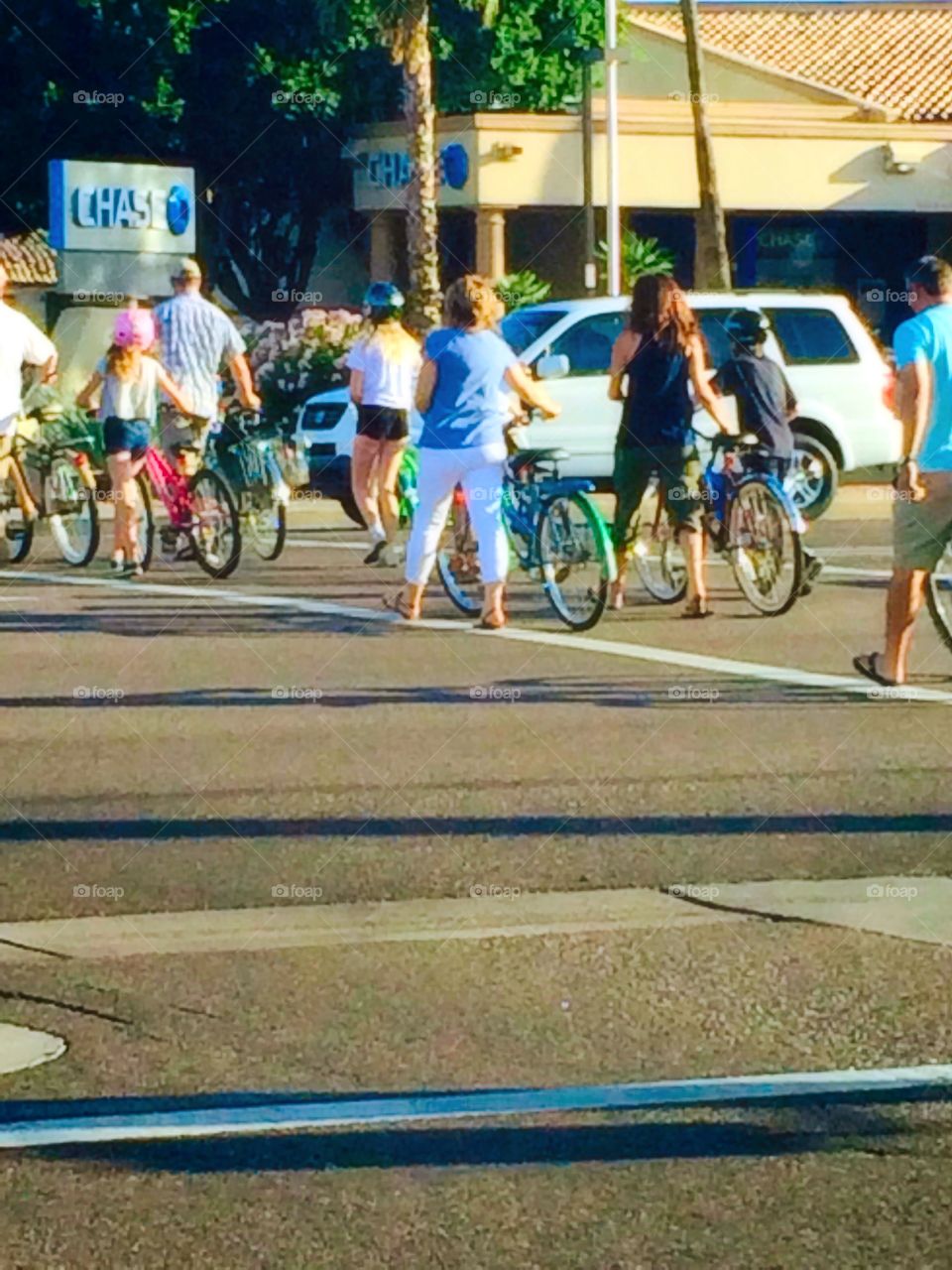 Family Safely Crossing the Street with Bikes