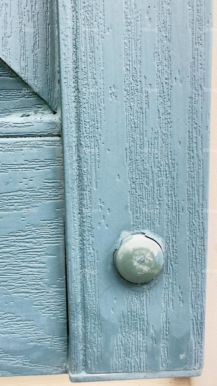 Nut bolt on a wooden pane.