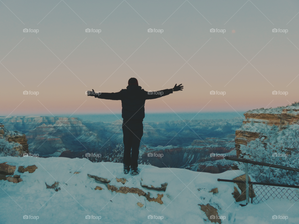 A man looking at the Grand Canyon