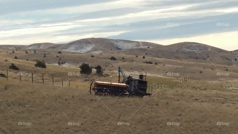 Old farm equipment left out in the field to retire