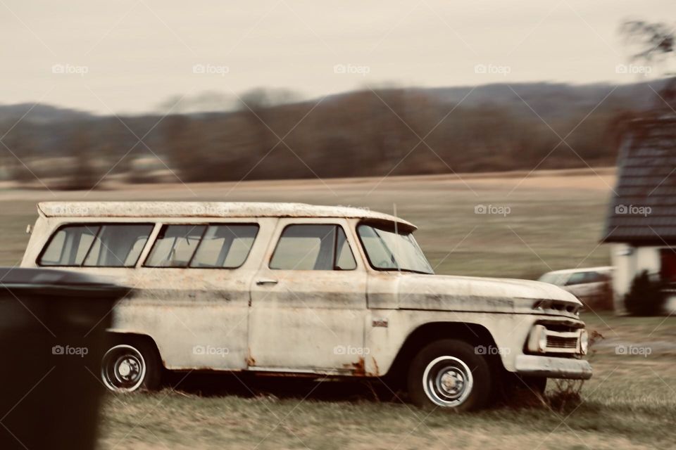 Old fashioned vintage car standing outside on a field 