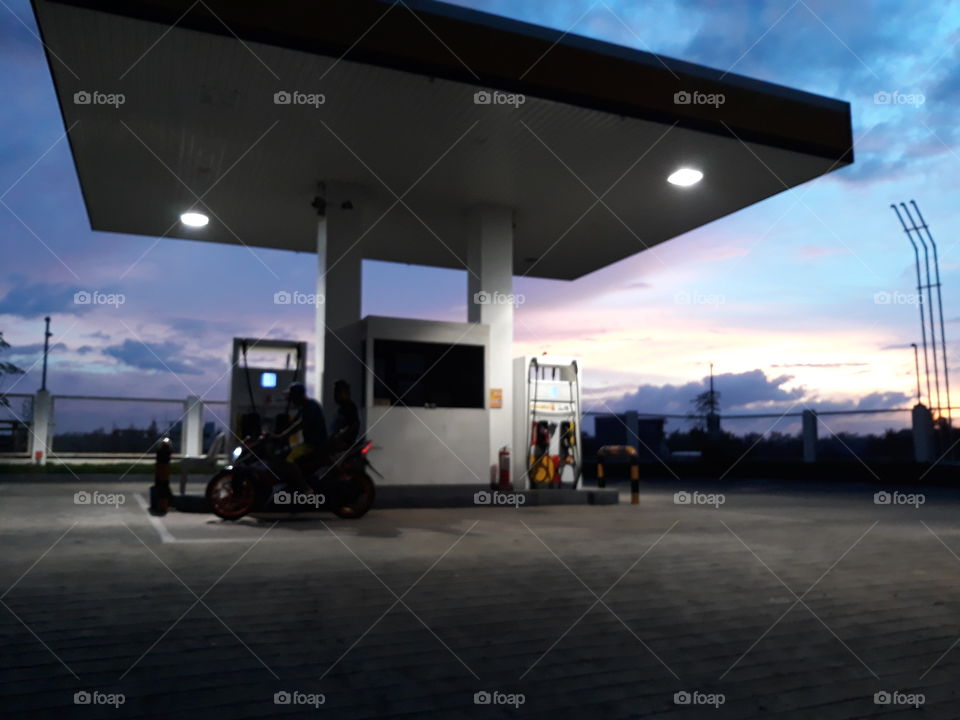 While making a tour in the suburbs of Iloilo, I was fascinated with the pink skies during sunset and stopped to take a photo on this newly opened shell station. What a spot!