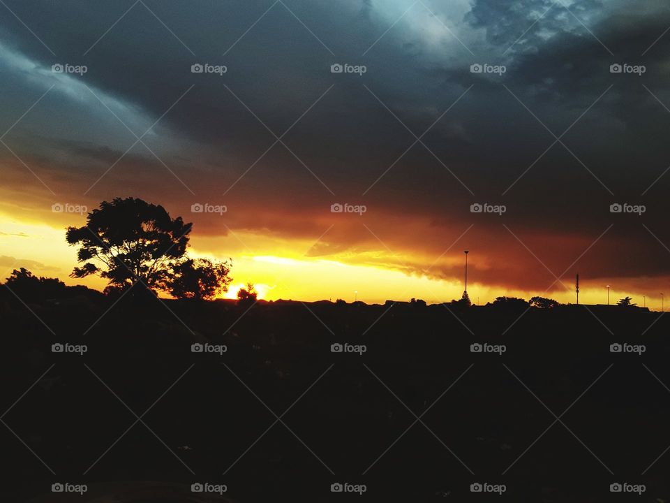 A golden sunset and the cloudy skies.