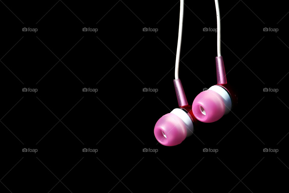 Earbud against black background