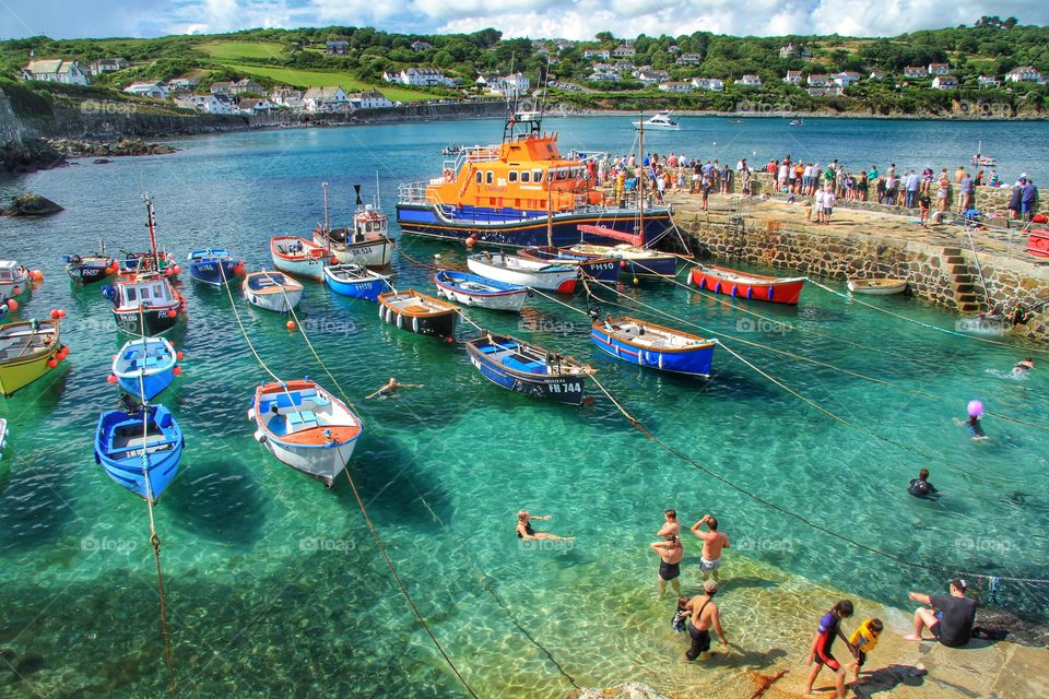 Holiday Harbour. A busy Cornish Harbour during RNLI Lifeboat day. The lifeboat visited Coverack and attracted lots of holidaymakers.