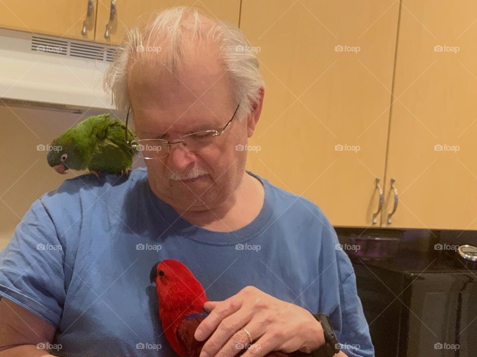 Very nice man with his 2 pet parrots.