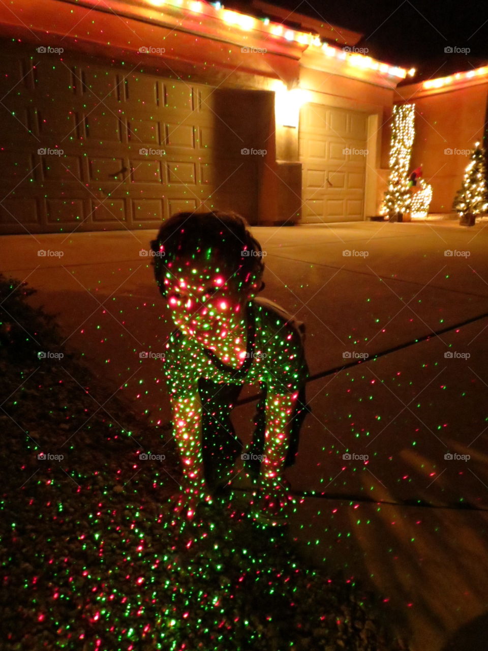 Boy lit up with fiber optic Christmas lights.