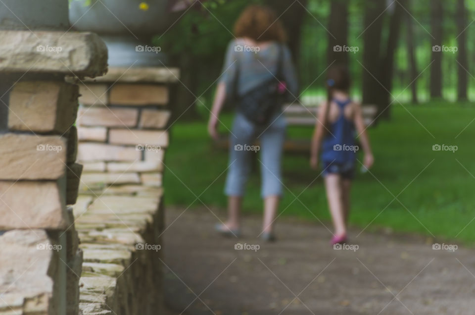 Mother and daughter walking in park