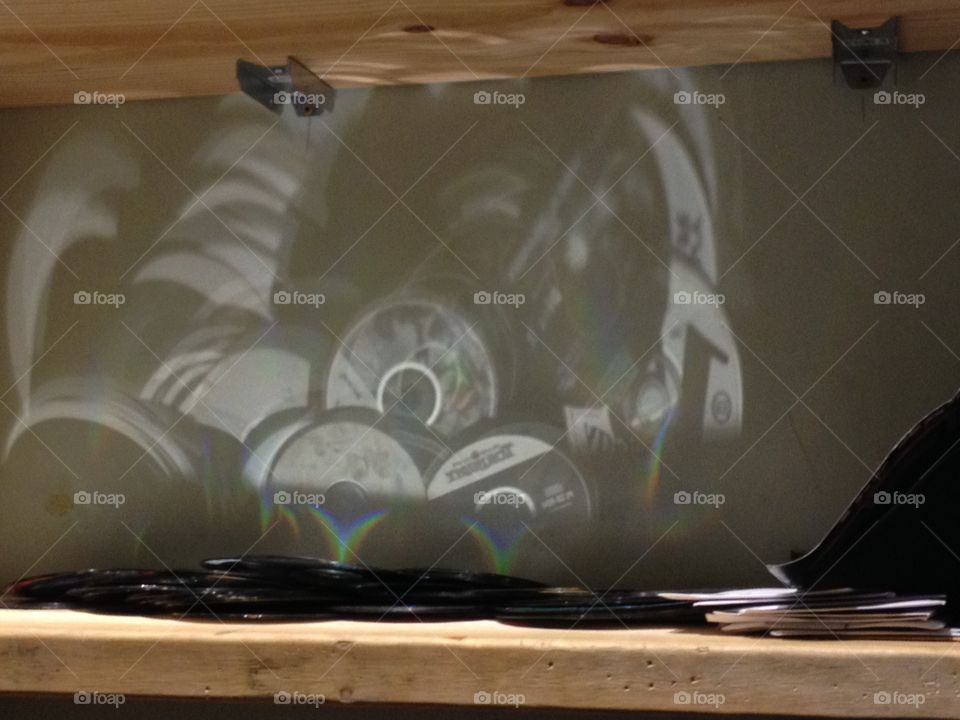 CDs reflection on a wall