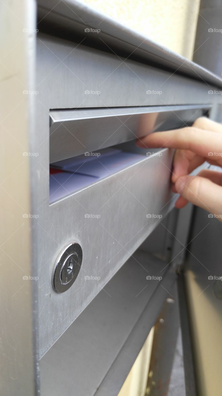 checking mailbox for letters and postcards