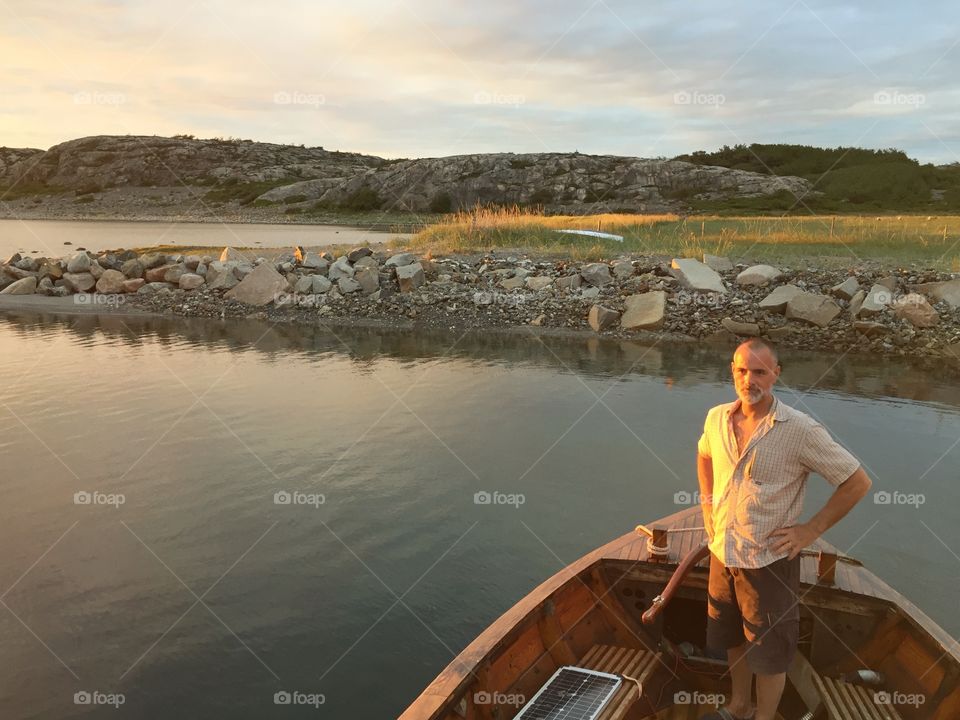 A man and hos old wooden boat