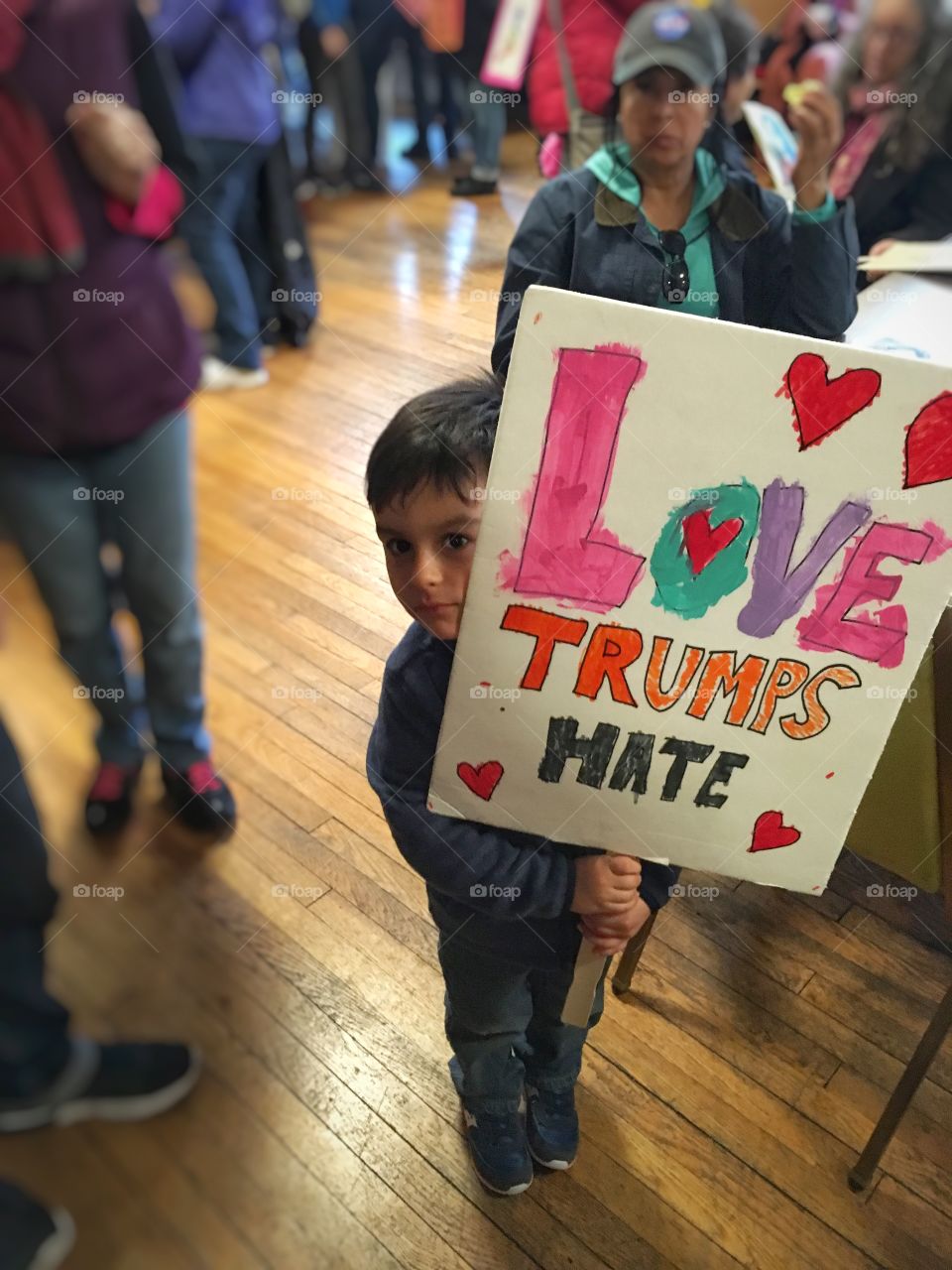 A little boy holding political supporter sign board