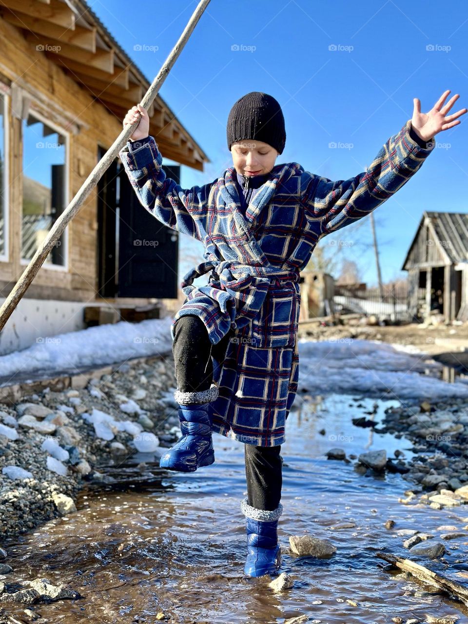 Boy stomping in a puddle