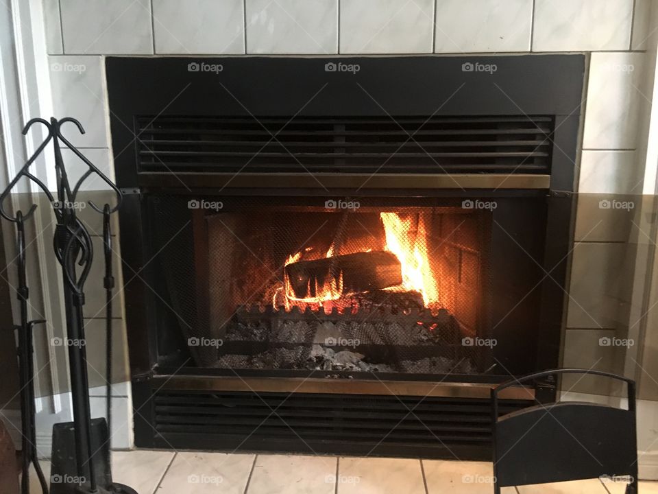A fire burns in a fireplace.
