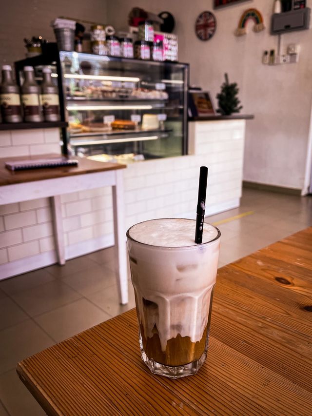 Caffe latte in a coffee shop. Interior of white and brown color