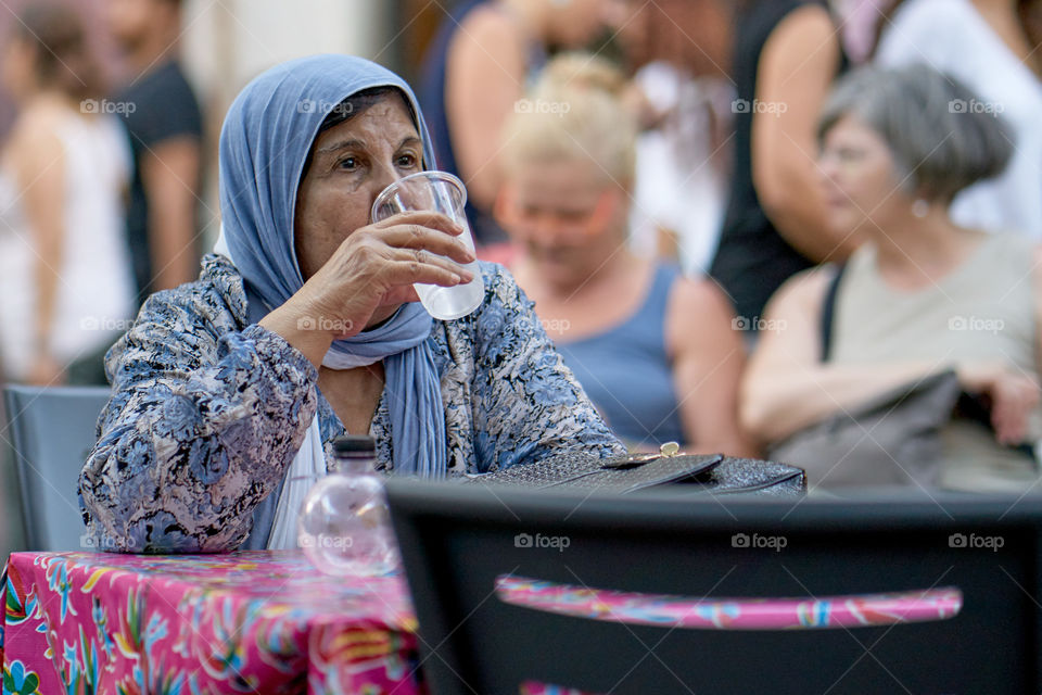 Elderly woman drinking water