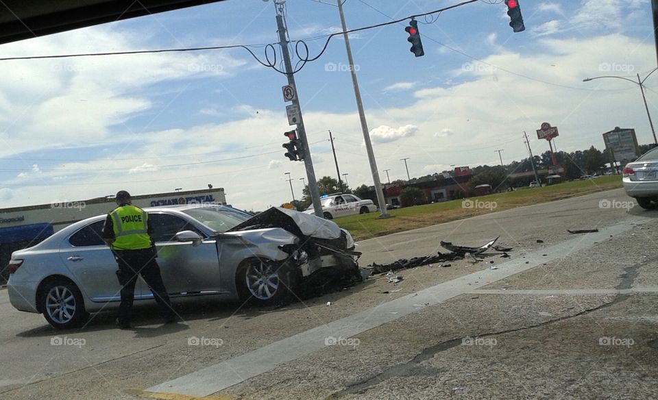 police at car wreck in main intersection.