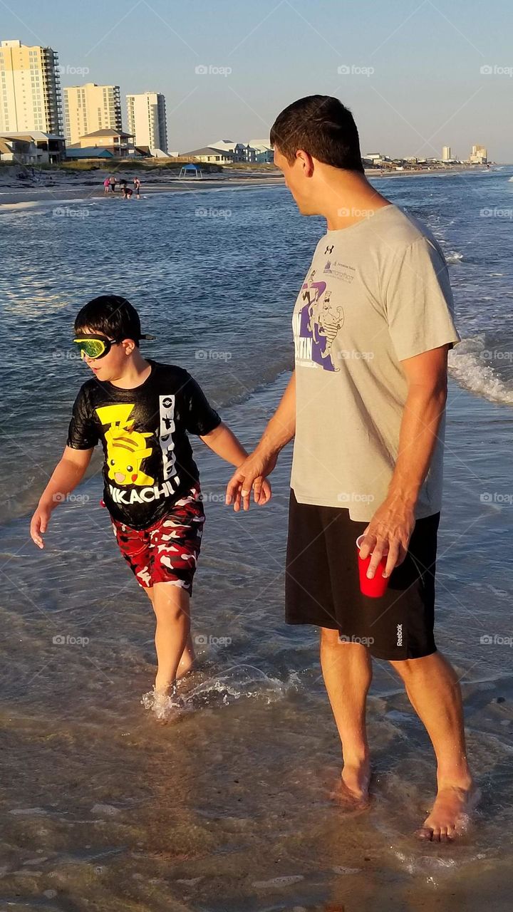Dad and son enjoying the beach at Gulf of Mexico
