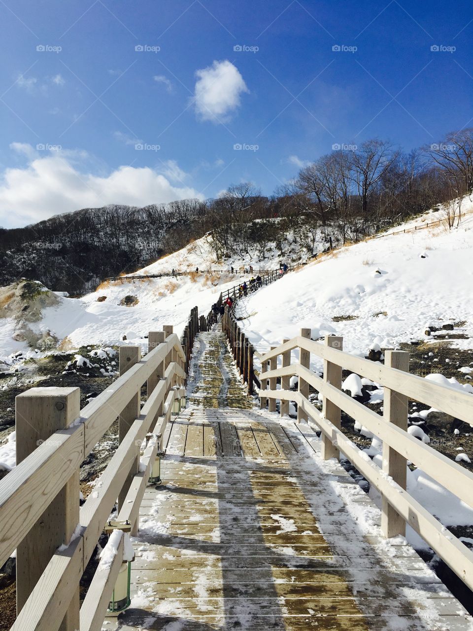 Wooden bridge and Snow mountains at noboribetsu, hokkaido, japan