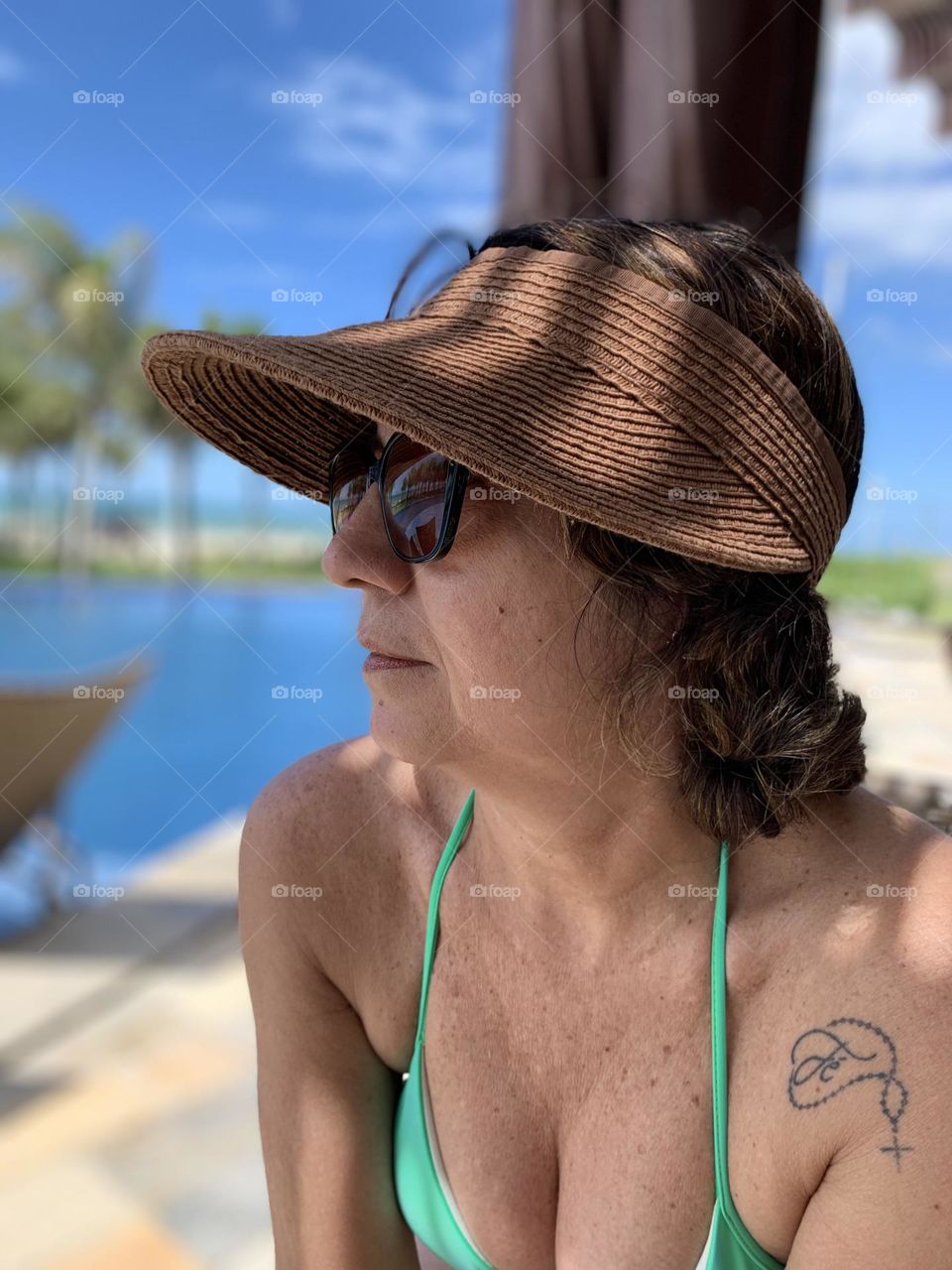 Woman wearing beach hat and sunglasses