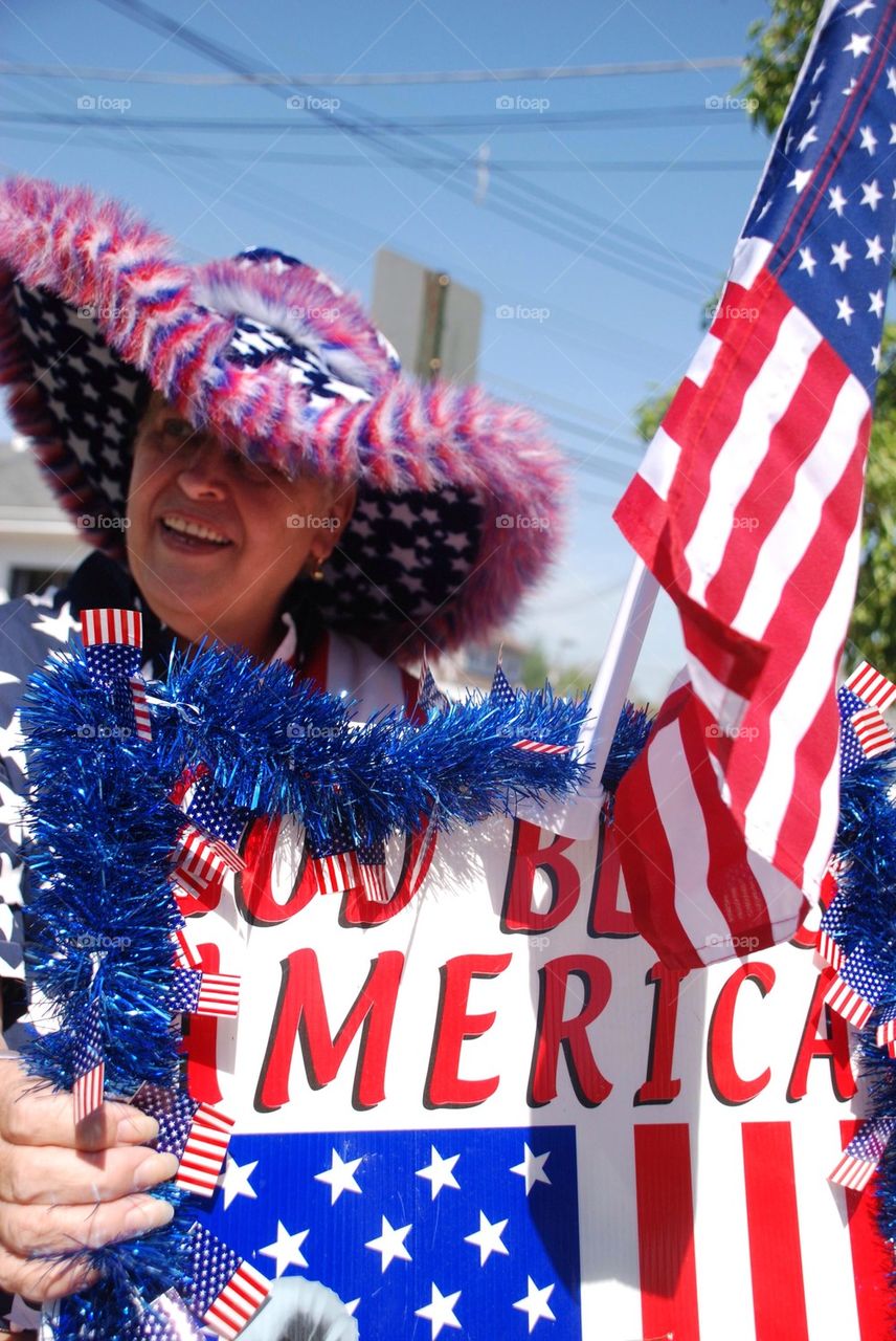 Patriotic woman with American flag and hat