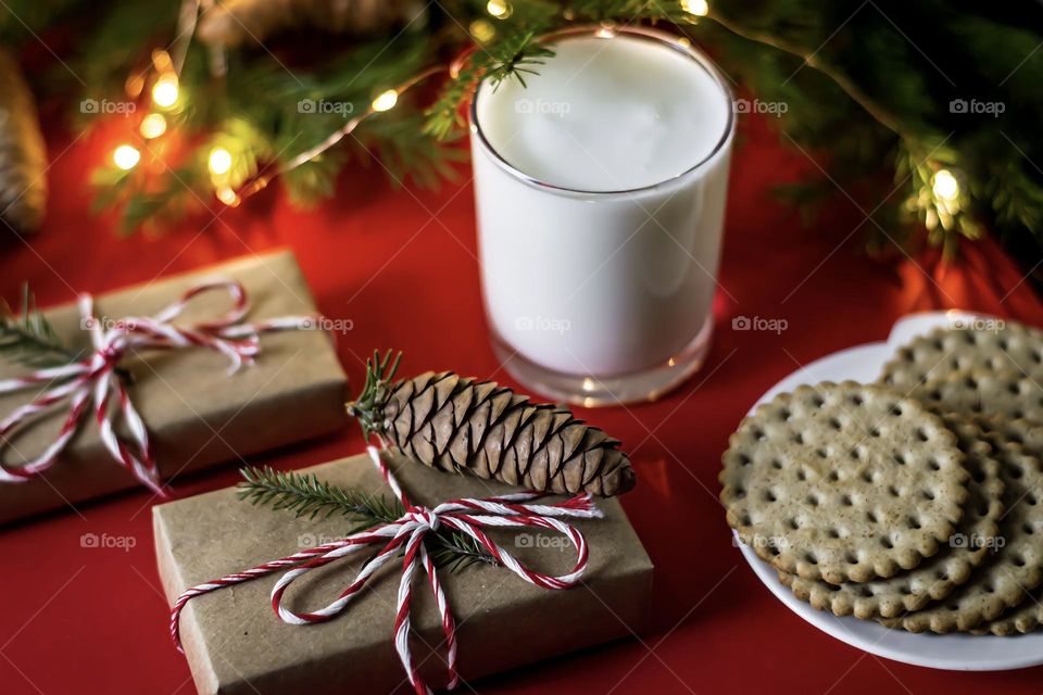 Christmas food composition on a red background, milk cookies for Santa and craft gifts