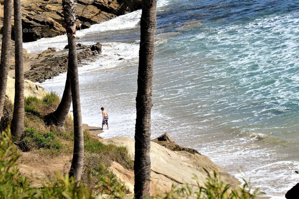 Kid is wondering around at the beach