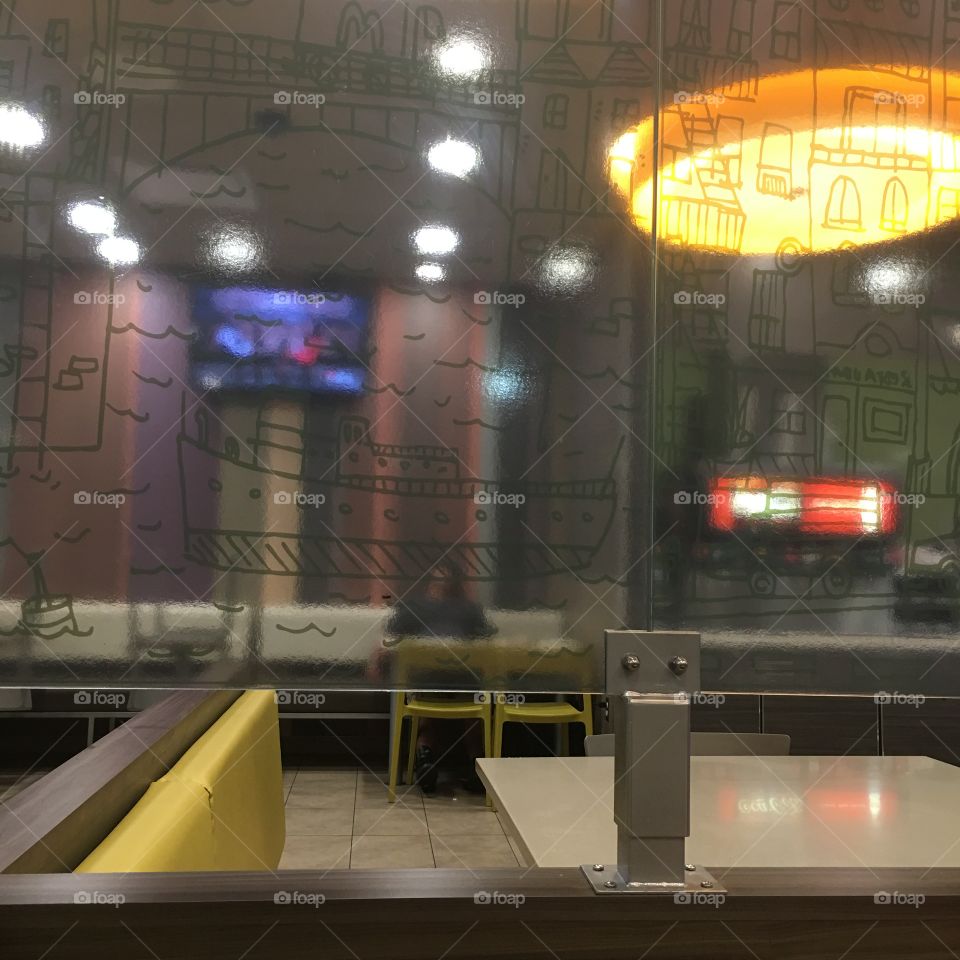 Sleeping pedestrian behind pattern partisan.  