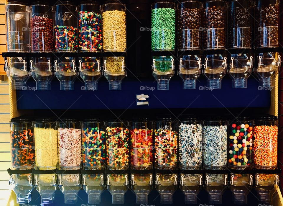 Old-fashioned candy store candy dispensers. Vintage candies. Gum balls. Lemon drops. Chocolates. M&Ms. 