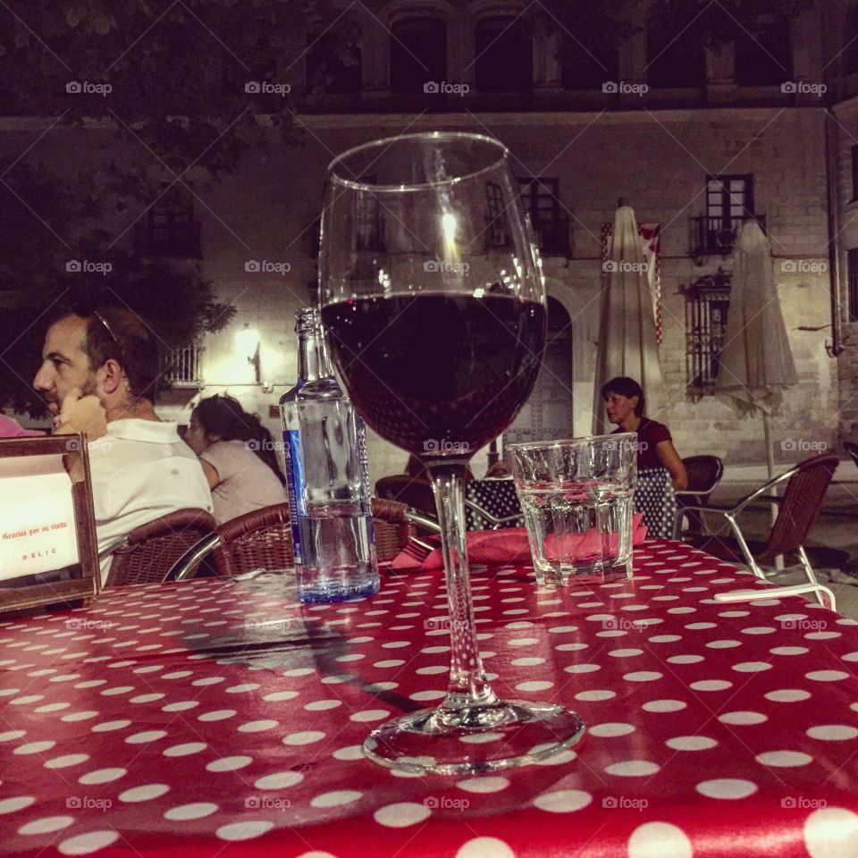 Wine on a table in a outdoors cafe in the summer night in Madrid 