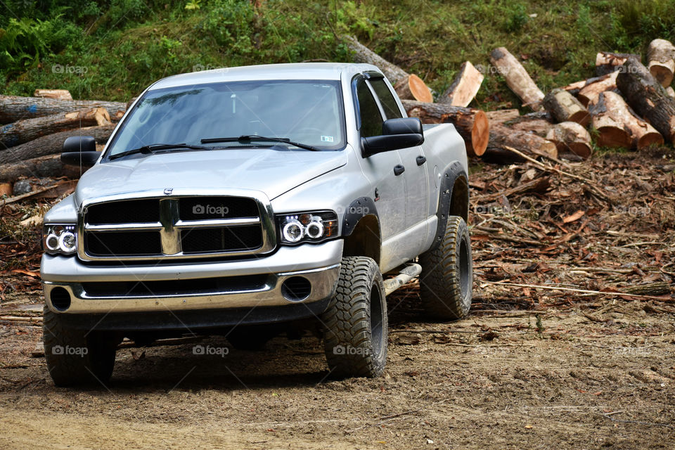 2005 Dodge ram 2500 on a logging road in front of logs