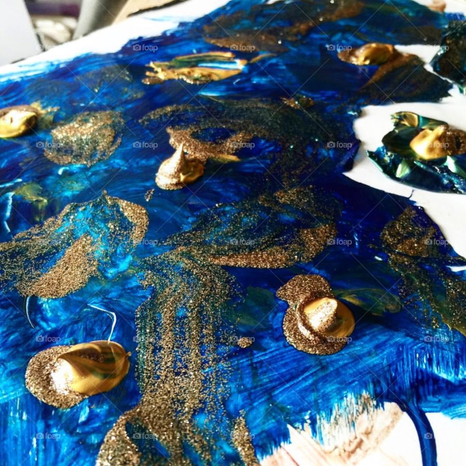 Painting with vivid blue and gold paint 